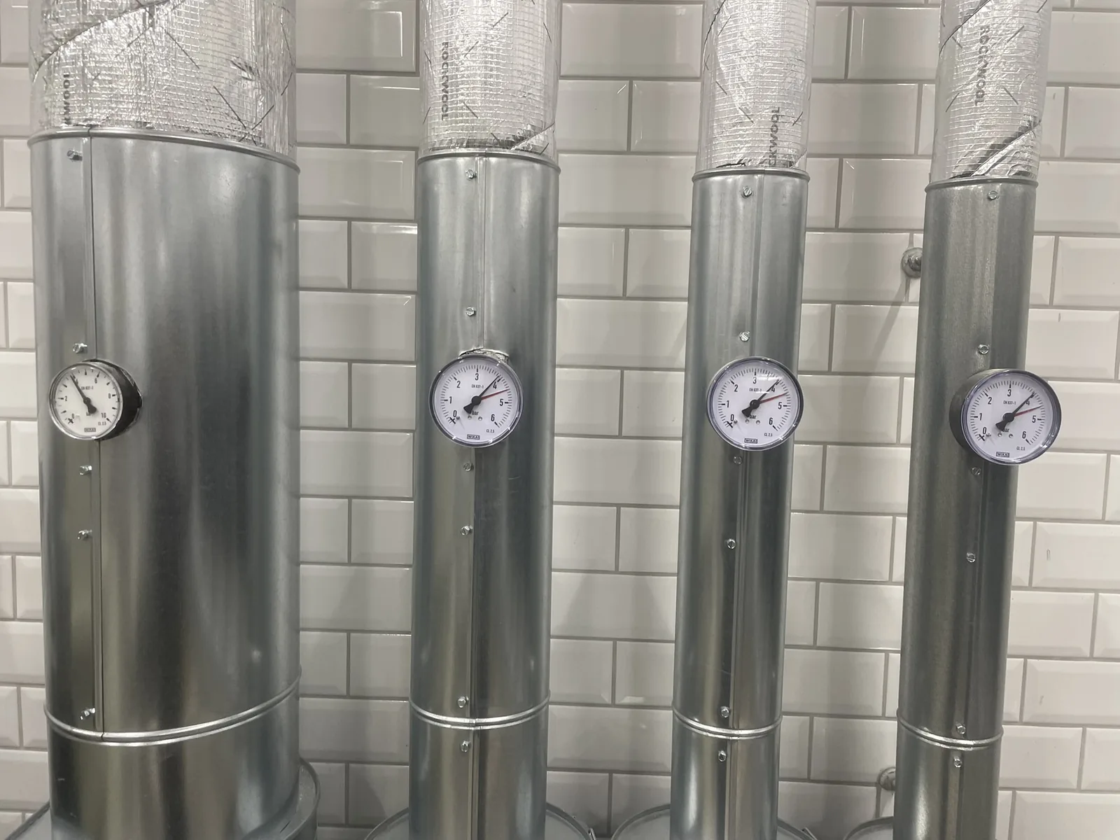 Insulated risers with pressure gauges in the plant room of the Voigtländer system at Frankfurt Airport